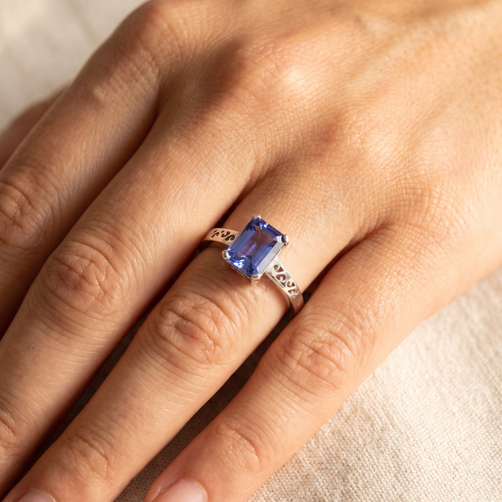 1.00 ct Emerald-Cut Tanzanite Solitaire Ring with Cut-Out Band in 14K White Gold, worn