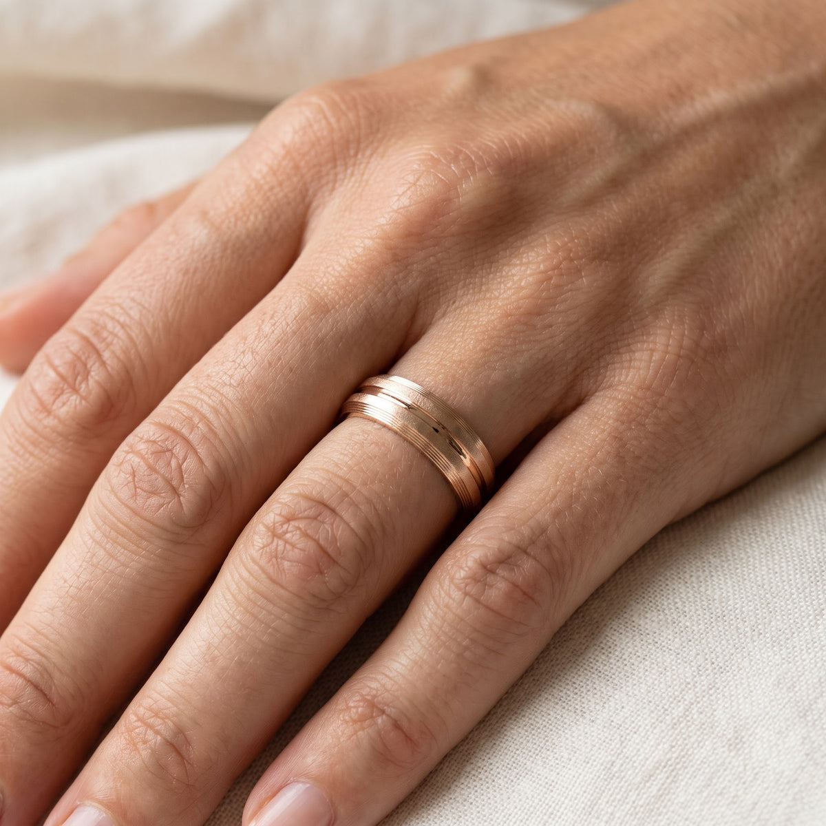 Textured Wedding Ring with Center Groove in 14K Rose Gold, worn