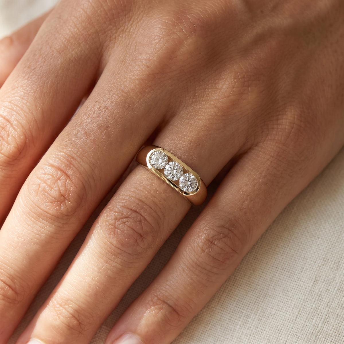 Three-Stone Round Diamond Flush Set Ring in 14K Yellow Gold, worn