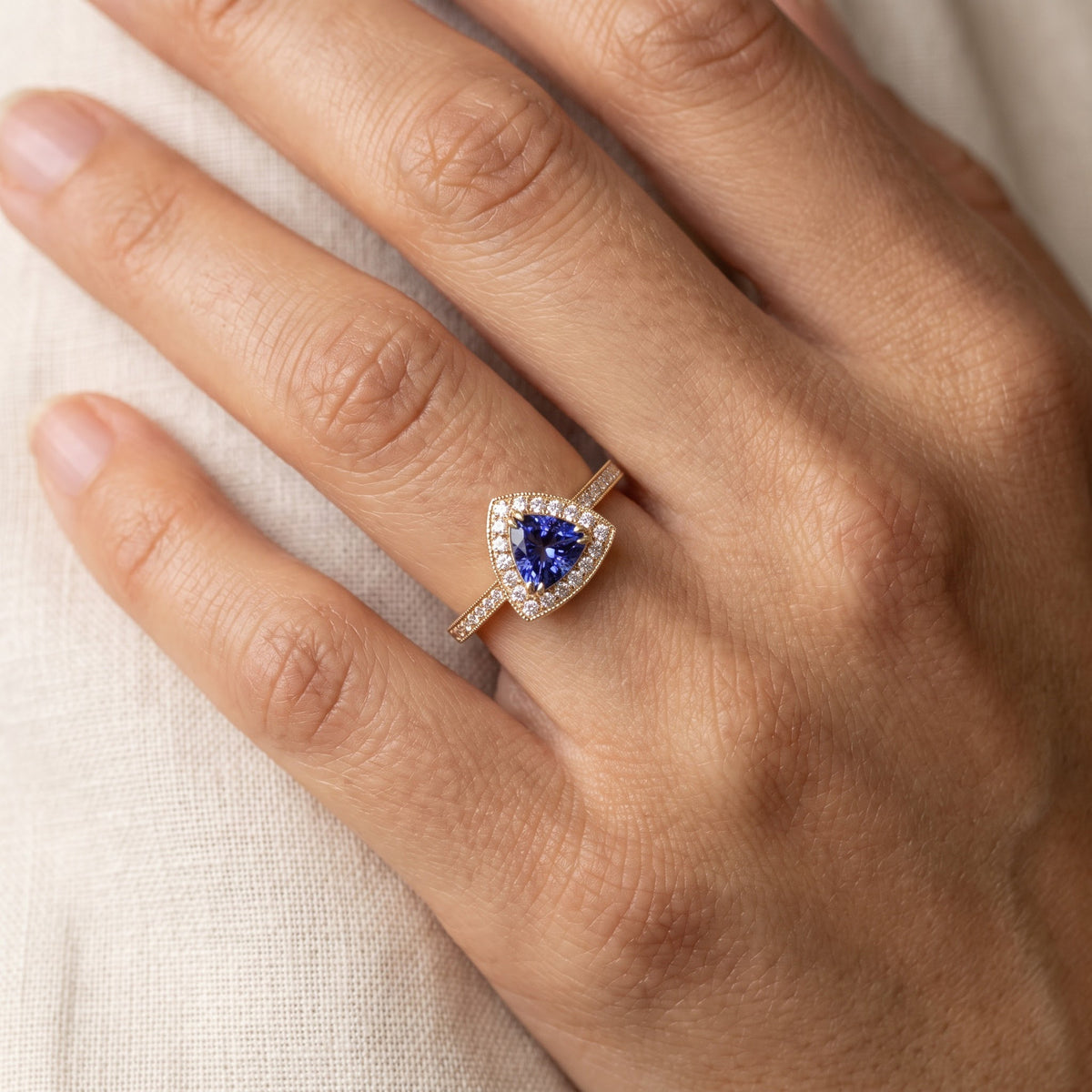 Trillion-Cut Tanzanite Halo Cocktail Ring in Yellow Gold, worn