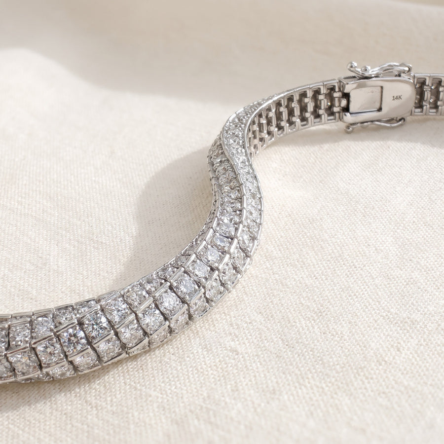 Wide white gold bracelet set with rows of round diamonds and a box clasp