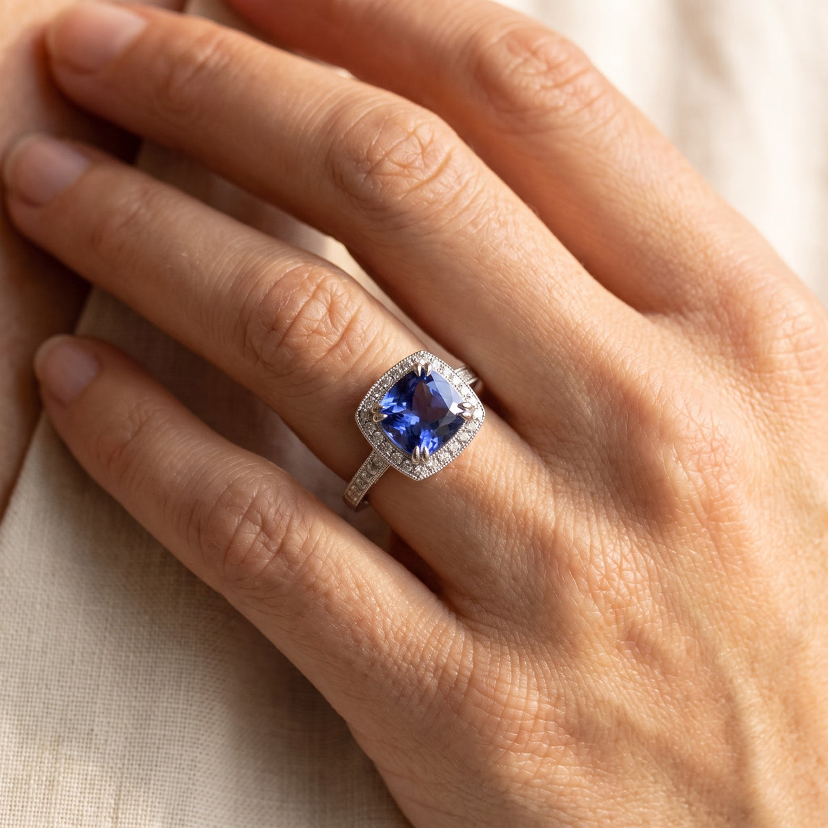White Gold Tanzanite Cushion Halo Cocktail Ring, worn