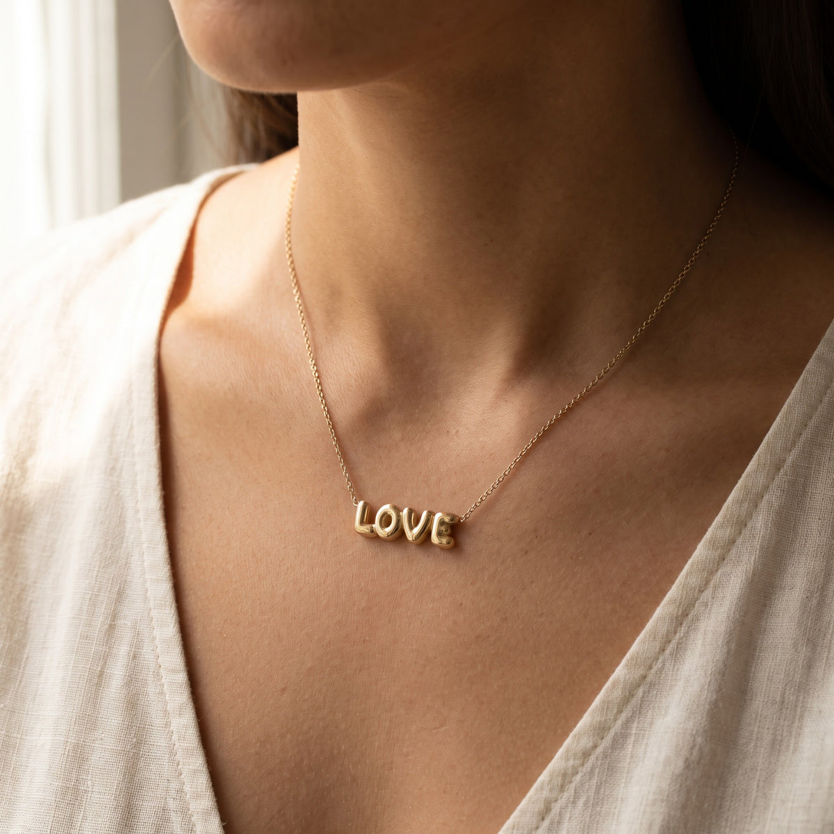 Yellow Gold Balloon Letter 'LOVE' Necklace, worn