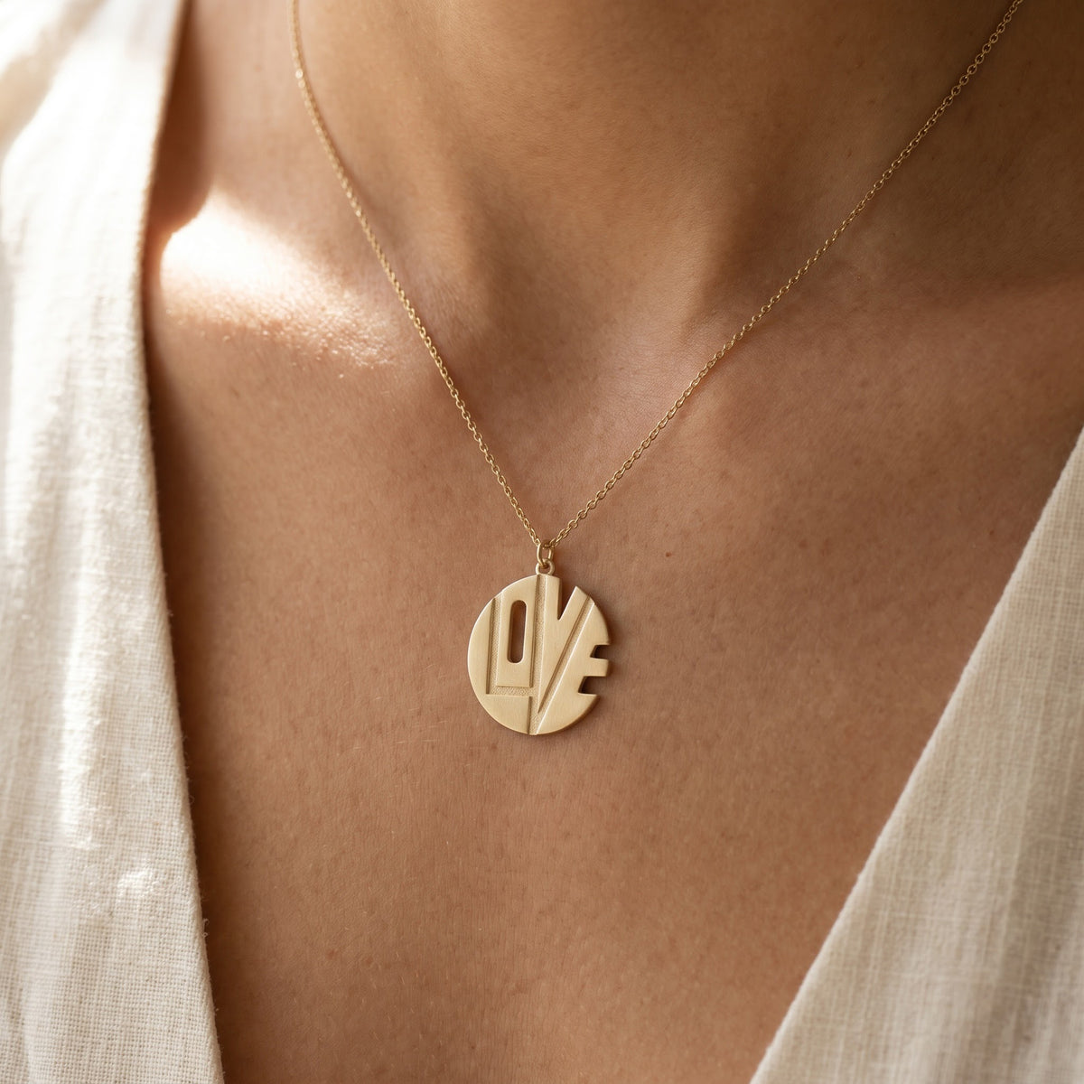 Yellow Gold Cutout "LOVE" Monogram Pendant Necklace, worn