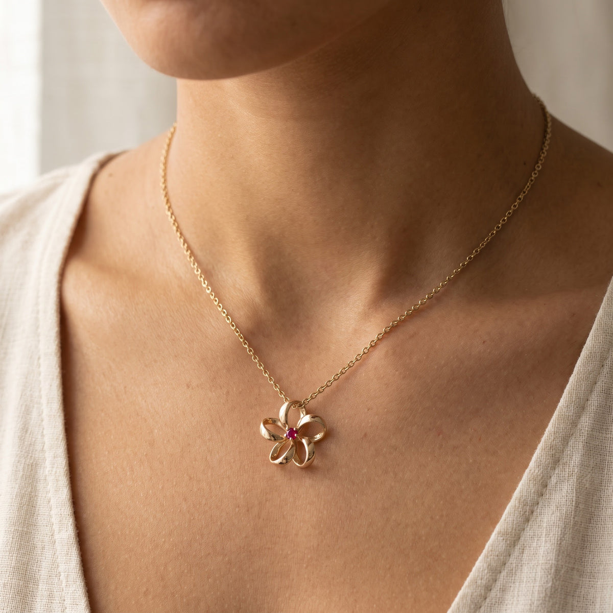 Yellow Gold Floral Charm Necklace with Red Ruby, worn