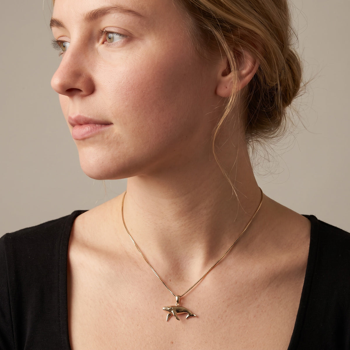 Yellow Gold Humpback Whale Charm Necklace with Sapphire Eye, worn, second view