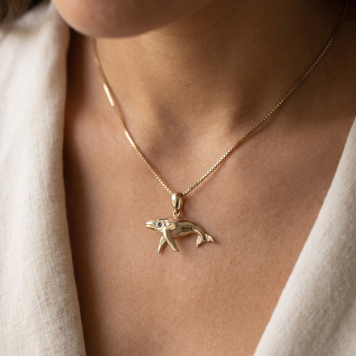Humpback Whale Charm Necklace with Blue Sapphire Eye in 14K Yellow Gold, worn