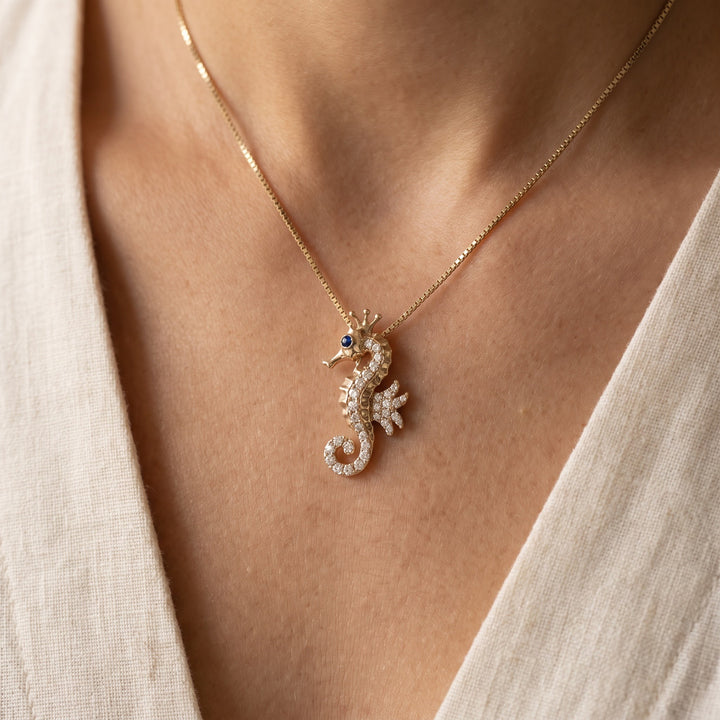 0.42 ct Diamond Seahorse Pendant with Blue Sapphire Eye in 14K Yellow Gold, worn